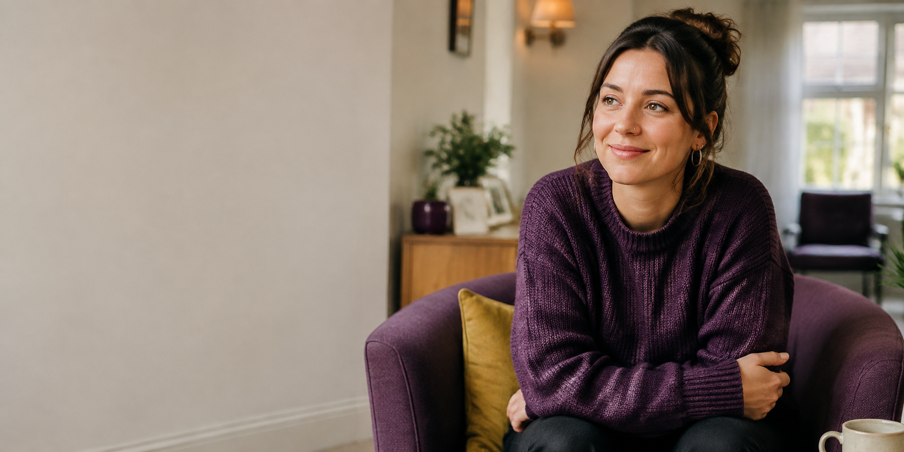 A younger woman sitting in a welcoming community room